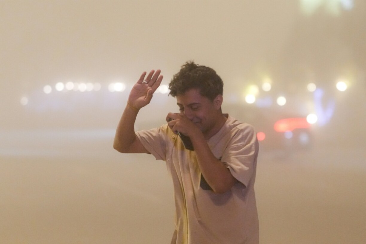 A pedestrian struggles to breathe as the sandstorm clogs the air with dust in the central Iraqi city of Najaf.