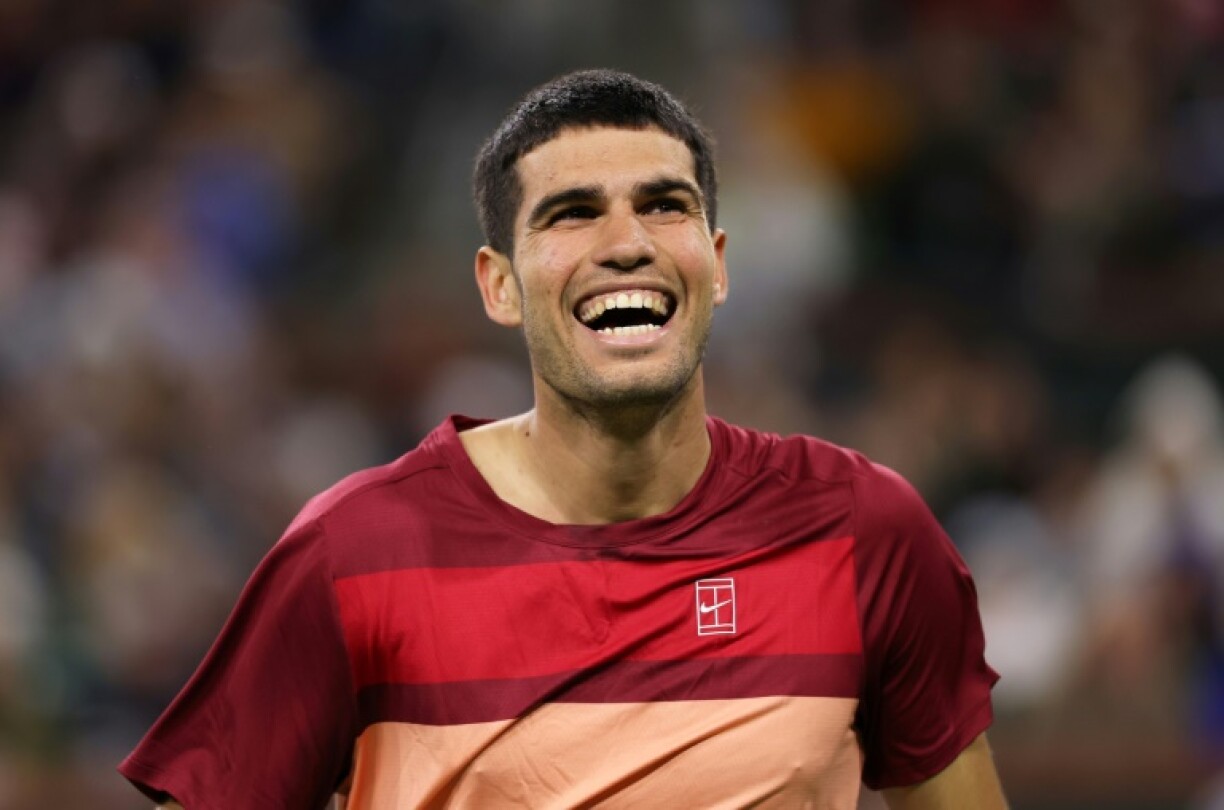 Two-time defending champion Carlos Alcaraz of Spain laughs after the wind blew a ball back into play during his fourth-round win over Grigor Dimitrov at Indian Wells
