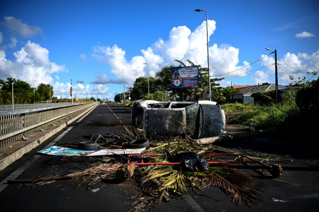 Une voiture incendiée sur un barrage au niveau du rond-point de Perrin aux Abymes, en Guadeloupe le 22 novembre 2022