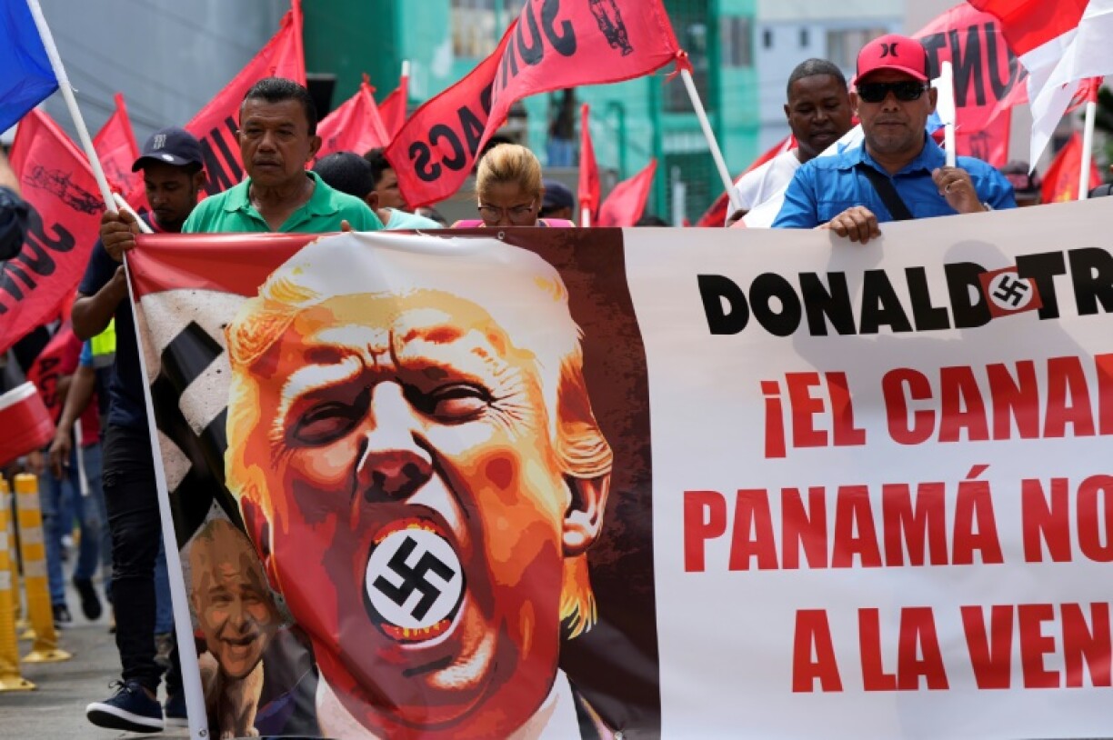 Demonstrators hold a banner reading 'The Panama Canal is not for sale' during a protest in Panama City against Donald Trump's inauguration