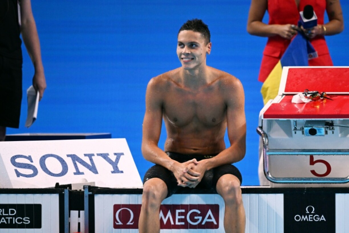 Romania's David Popovici completed a 100m-200m sprint double at swimming's world championships in Singapore