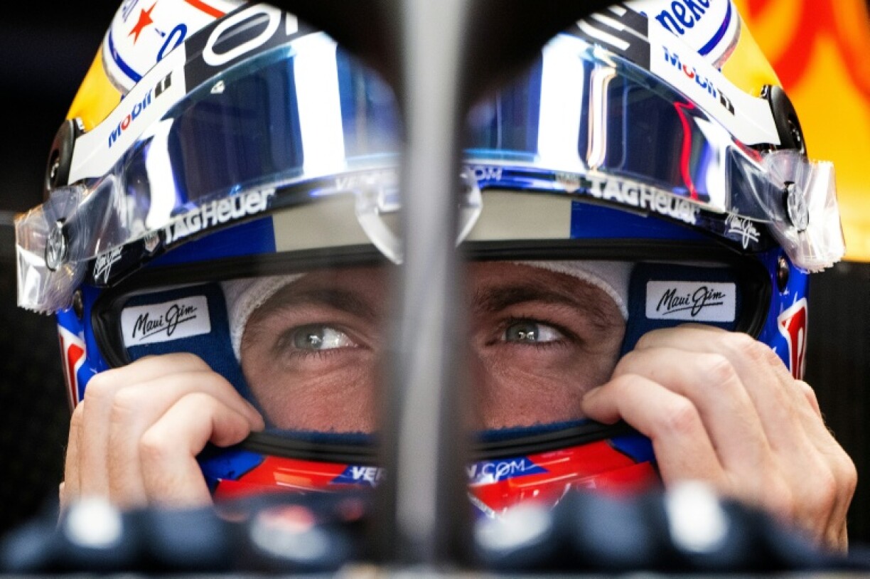 Red Bull Racing's Dutch driver Max Verstappen secures his helmet during practice for the United States Formula One Grand Prix at the Circuit of the Americas in Austin, Texas