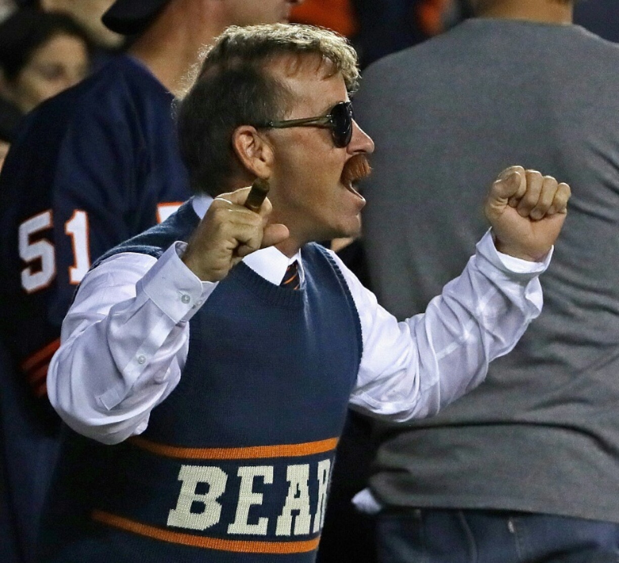 A Chicago Bears fan, dressed as former coach Mike Ditka circa 1985, cheers on his team in 2019
