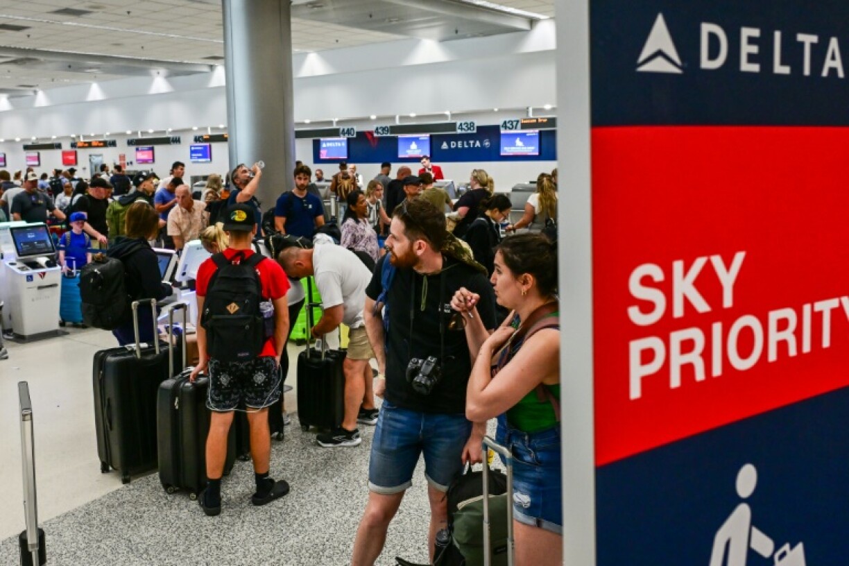 Travelers queue at Miami International Airport on May 24, 2025