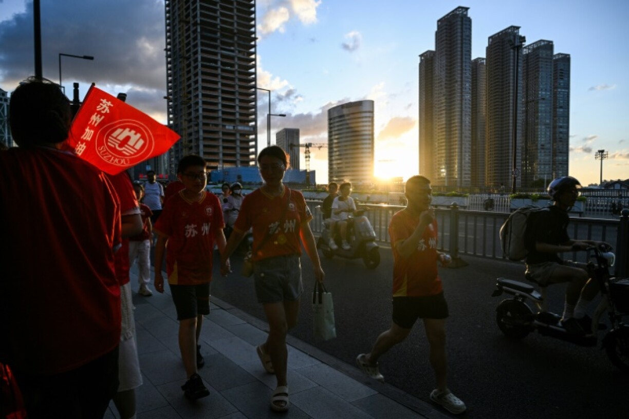 Fans walk to the stadium to watch the amateur league football match between Suzhou and Zhenjiang at the Suzhou Sport Center