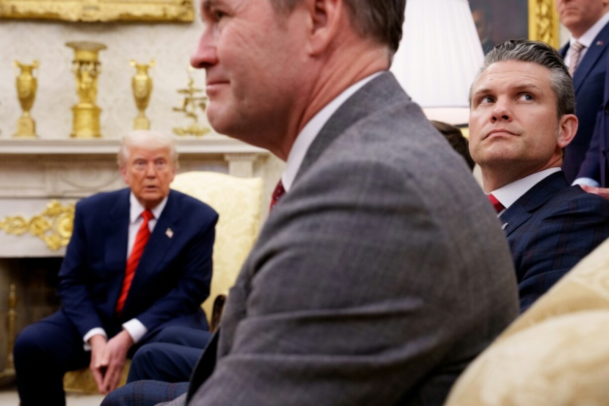 US National Security Advisor Michael Waltz (C) and Defense Secretary Pete Hegseth (R) are seen at a White House meeting with President Donald Trump on March 13, 2025