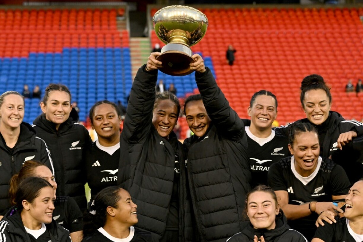 New Zealand's Kennedy Tukuafu and Ruahei Demant (C) lift the O'Reilly Cup to celebrate with teammates following their series win in the Pacific Four Test Series women's rugby match against Australia in Newcastle, New South Wales, in May