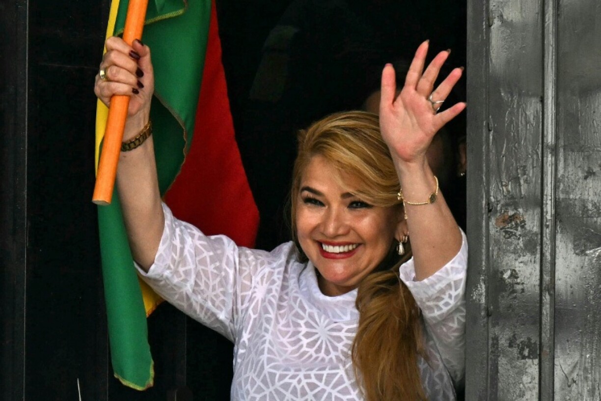 Former Bolivian President Jeanine Anez waves as she is released from the Miraflores women's prison in La Paz after having her 10-year prison sentence for alleged coup plotting annuled