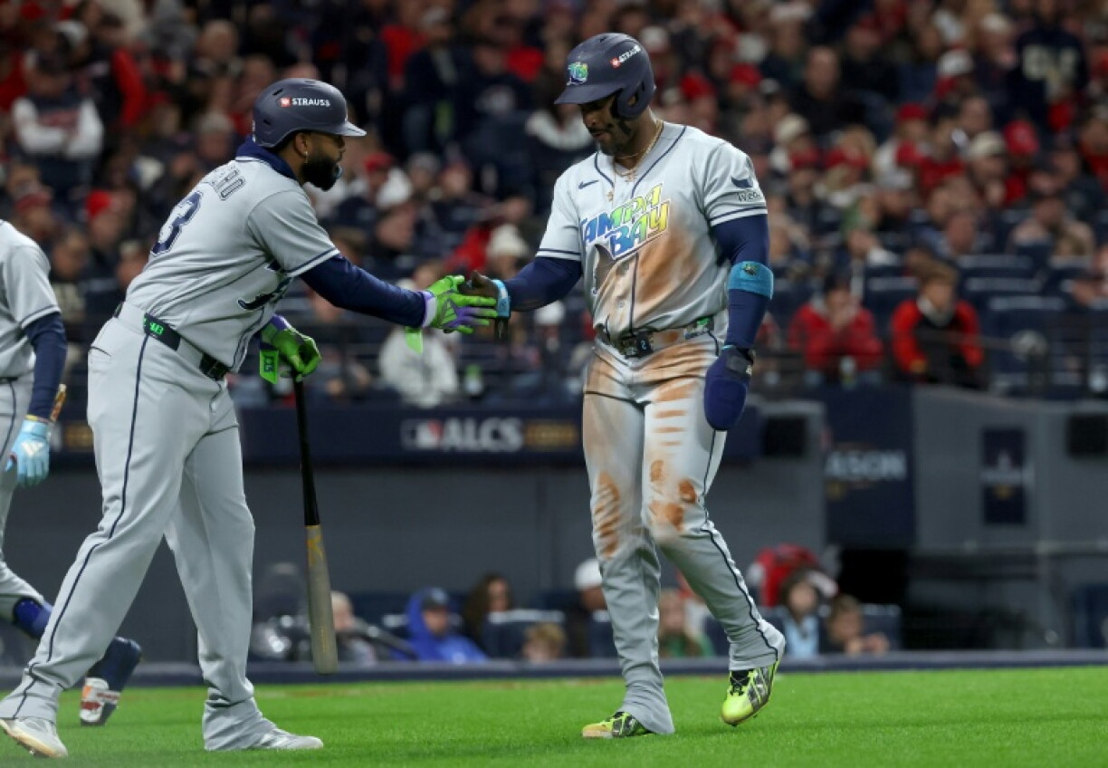 Tampa Bay's Yandy Diaz (right) scored a late home run in a series-leveling victory over former club Cleveland in the MLB playoffs
