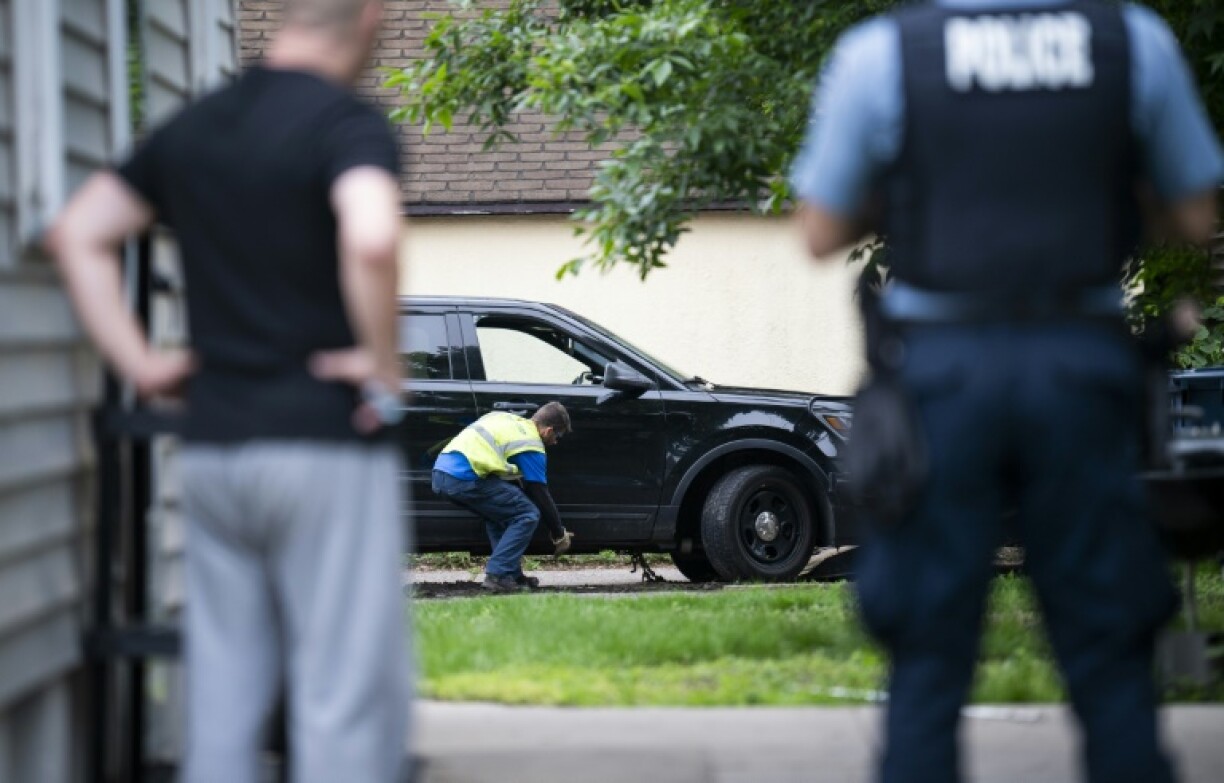 A vehicle belonging to Vance Boelter, a primary suspect in the murder of a Minnesota lawmaker and her husband, is towed from the alley behind his home