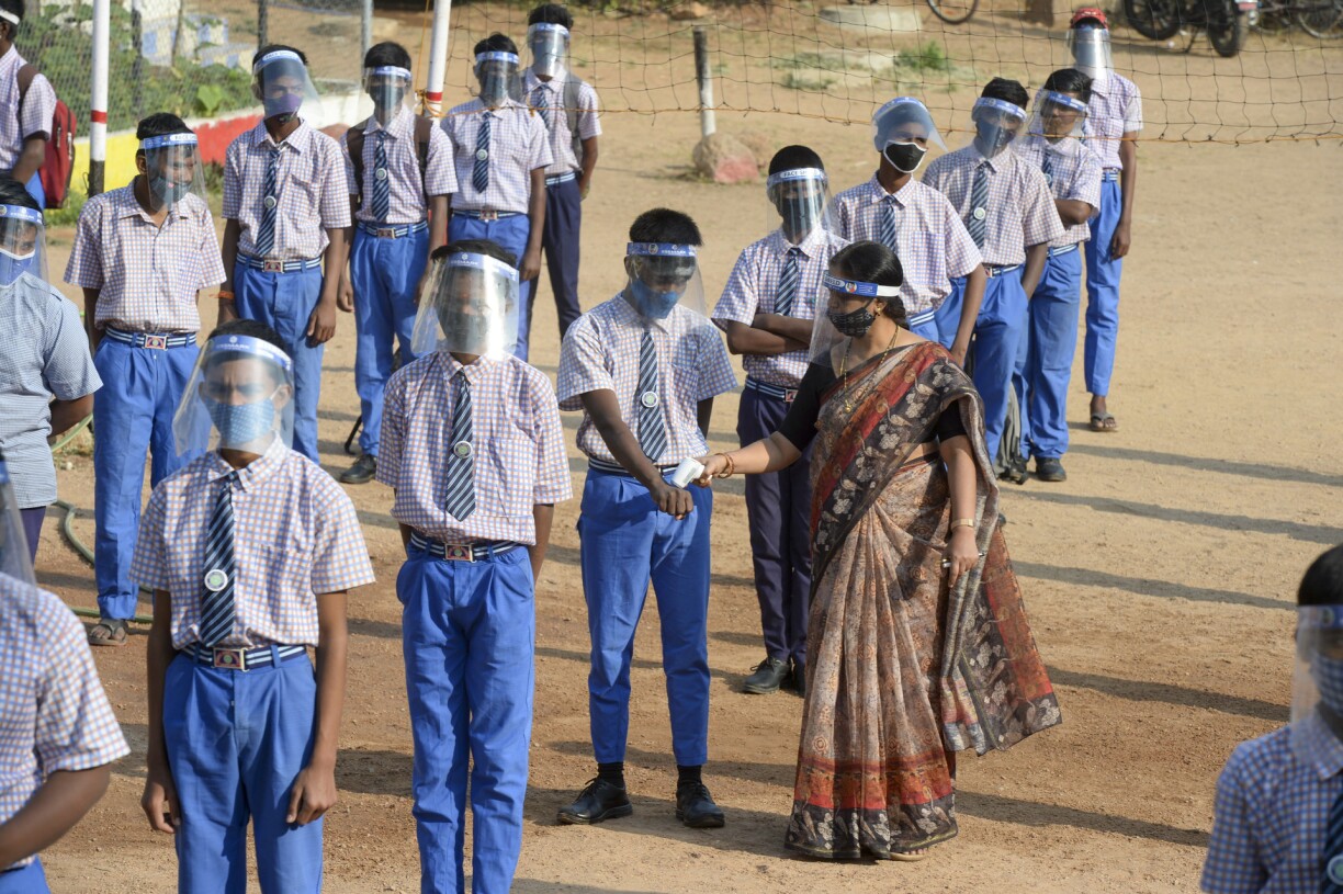 Students wearing facemasks and face-shields attend an assembly after their school reopened for the 9th and 10th grades following nearly ten months closure due to the Covid-19 coronavirus pandemic in Hyderabad, India, on February 6, 2021.