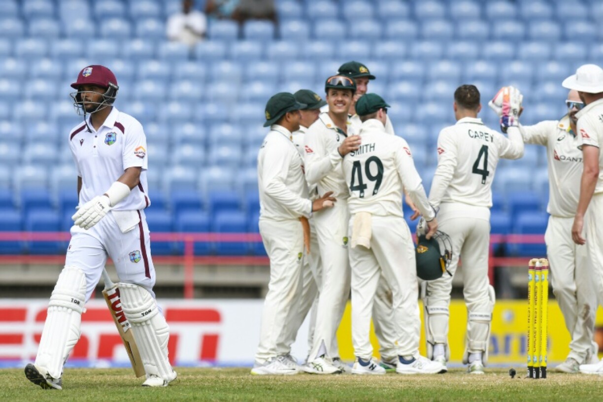 Australia celebrate Brandon King's (left) dismissal