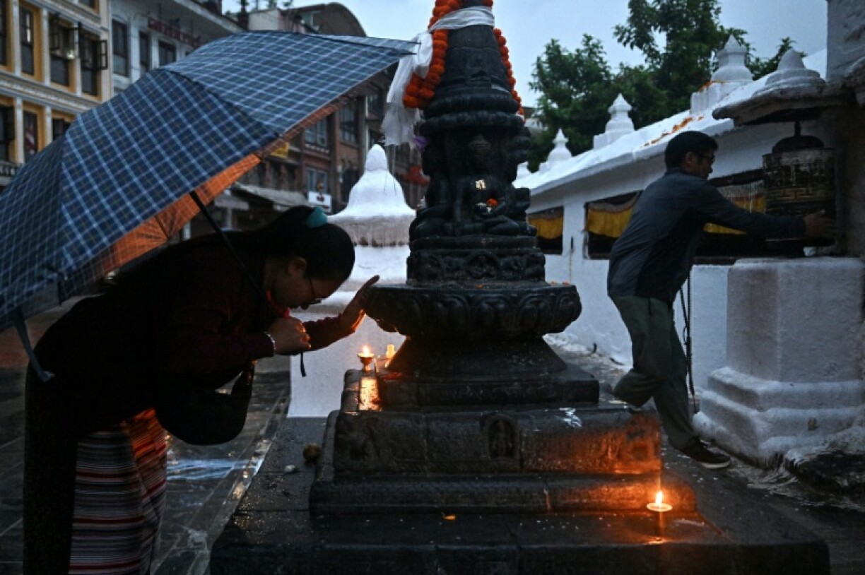 Buddhist devotees offer prayers at the Boudhanath Stupa in Kathmandu as Nepal takes a step back towards normality