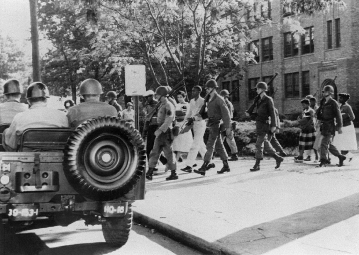Nine black children are escorted from Central High School by US troops on 25 September 1957 in Little Rock, Arkansas after US President Dwight Eisenhower decided to send the military to the state to protect Black students