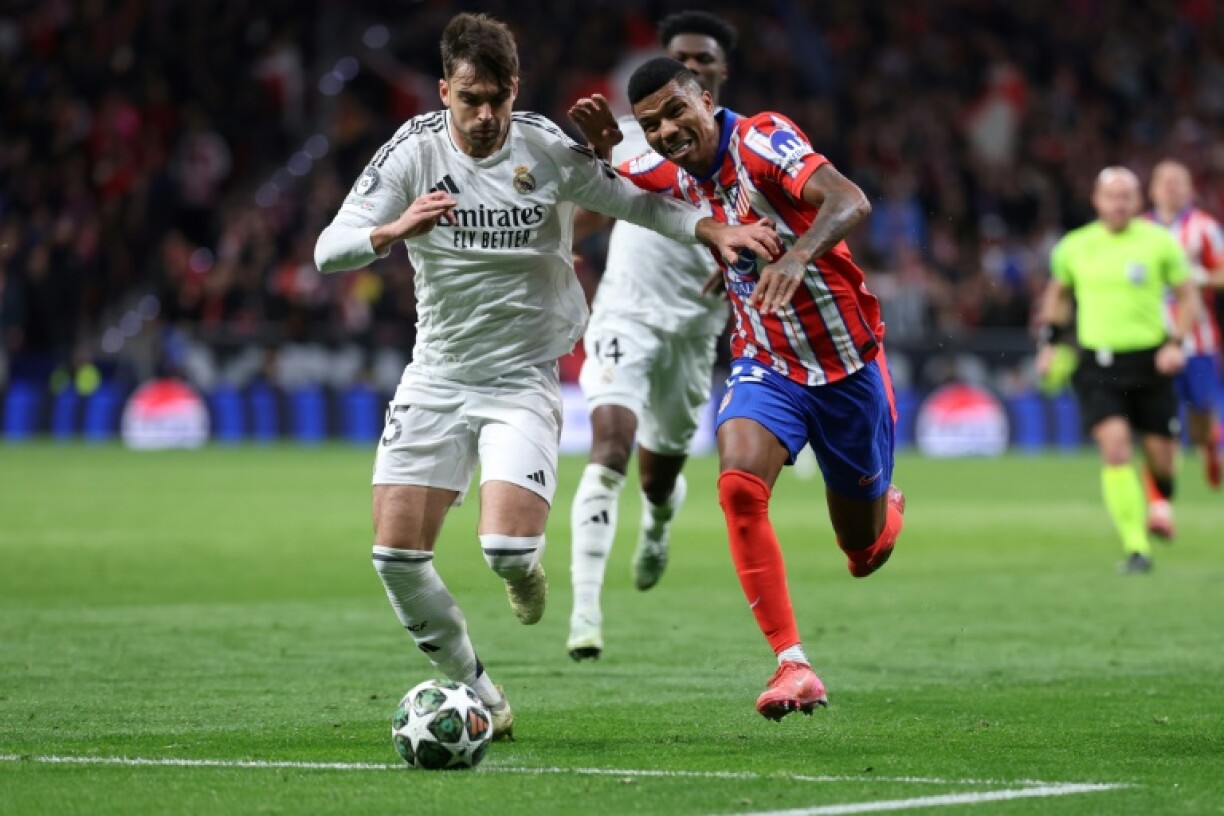 Real Madrid's Spanish defender Raul Asencio (L)