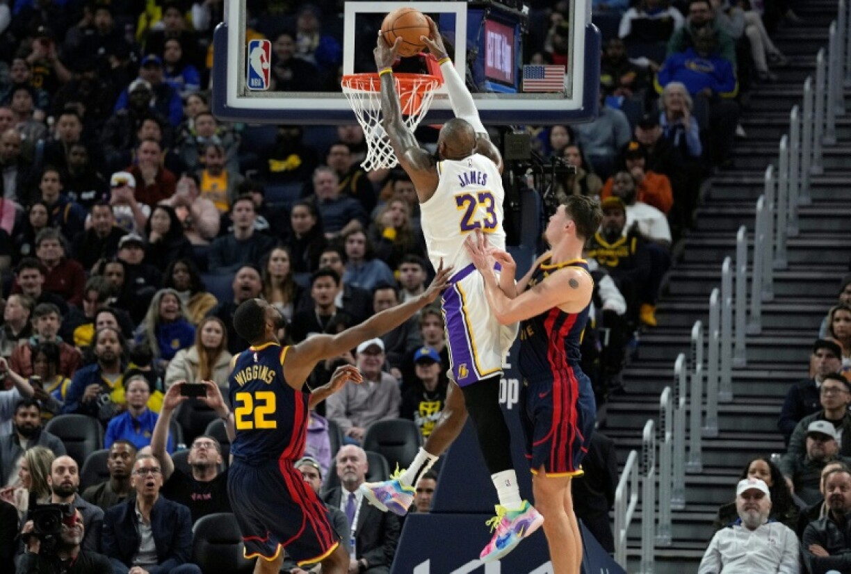 LeBron James of the Los Angeles Lakers slam dunks in the Lakers' NBA victory over the Golden State Warriors