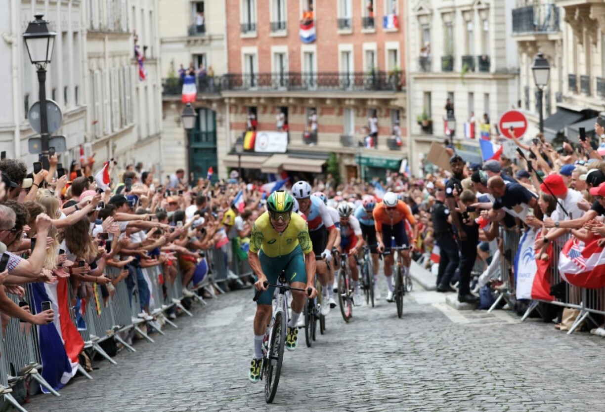 Riders in the 2024 men's Olympic road race navigate the cobbled roads of Montrmartre