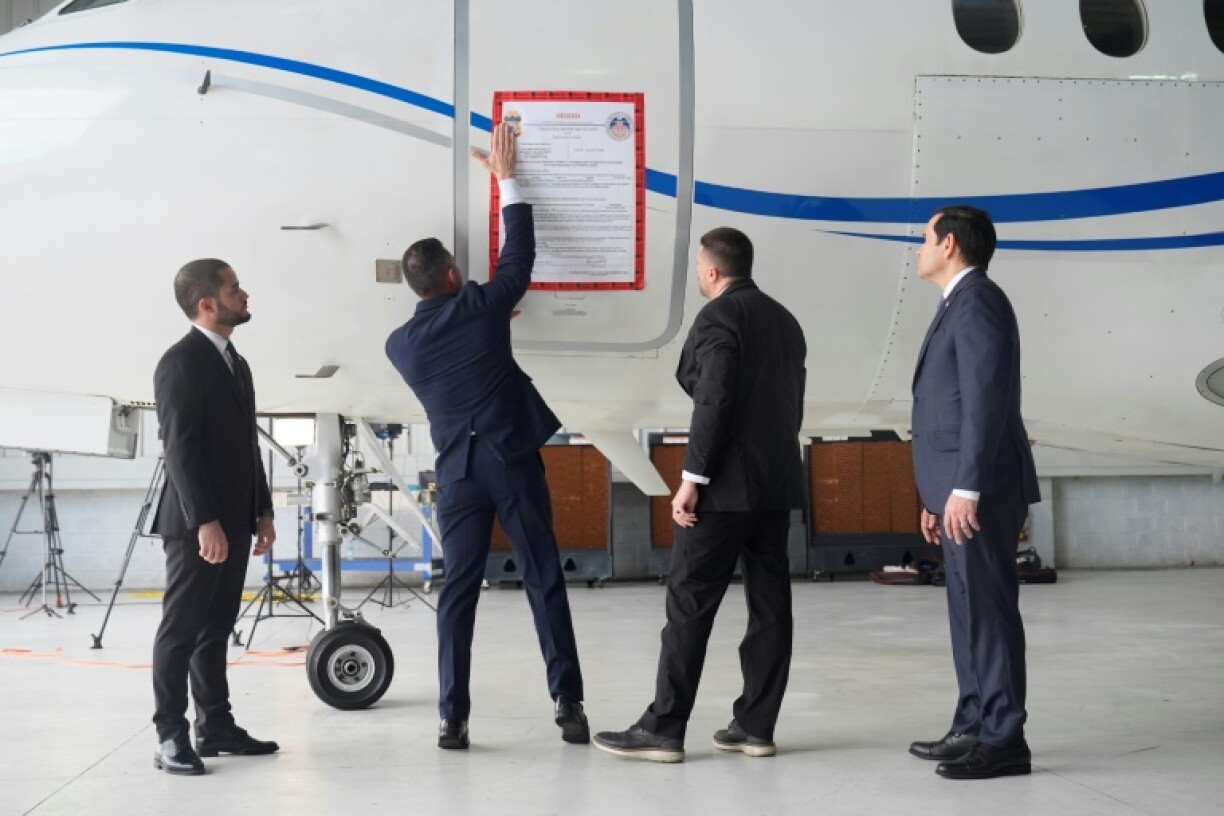 A “seized” sign is placed on a Venezuelan government airplane during a press conference where US Secretary of State Marco Rubio (R) announced its seizure in Santo Domingo, the Dominican Republic, on February 6, 2025.