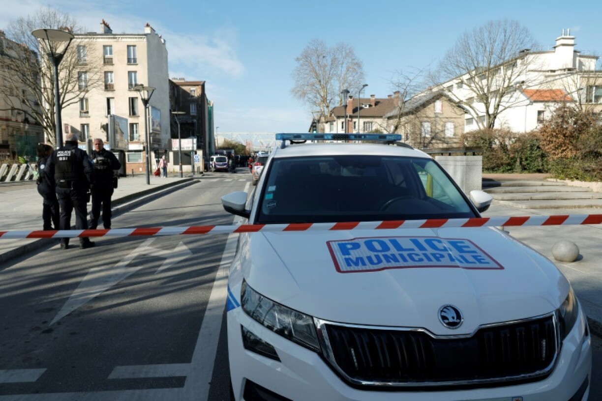 French police officers block access to the SNCF's freight area in the northern Paris suburb of Saint-Denis following the discovery of a World War II bomb