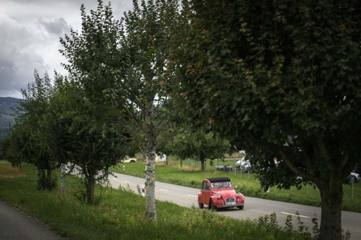 Une Citroen 2CV arrive près de Delemont, dans le nord de la Suisse, le 26 juillet 2023, pour la 24e Rencontre mondiale des Amis de la 2CV