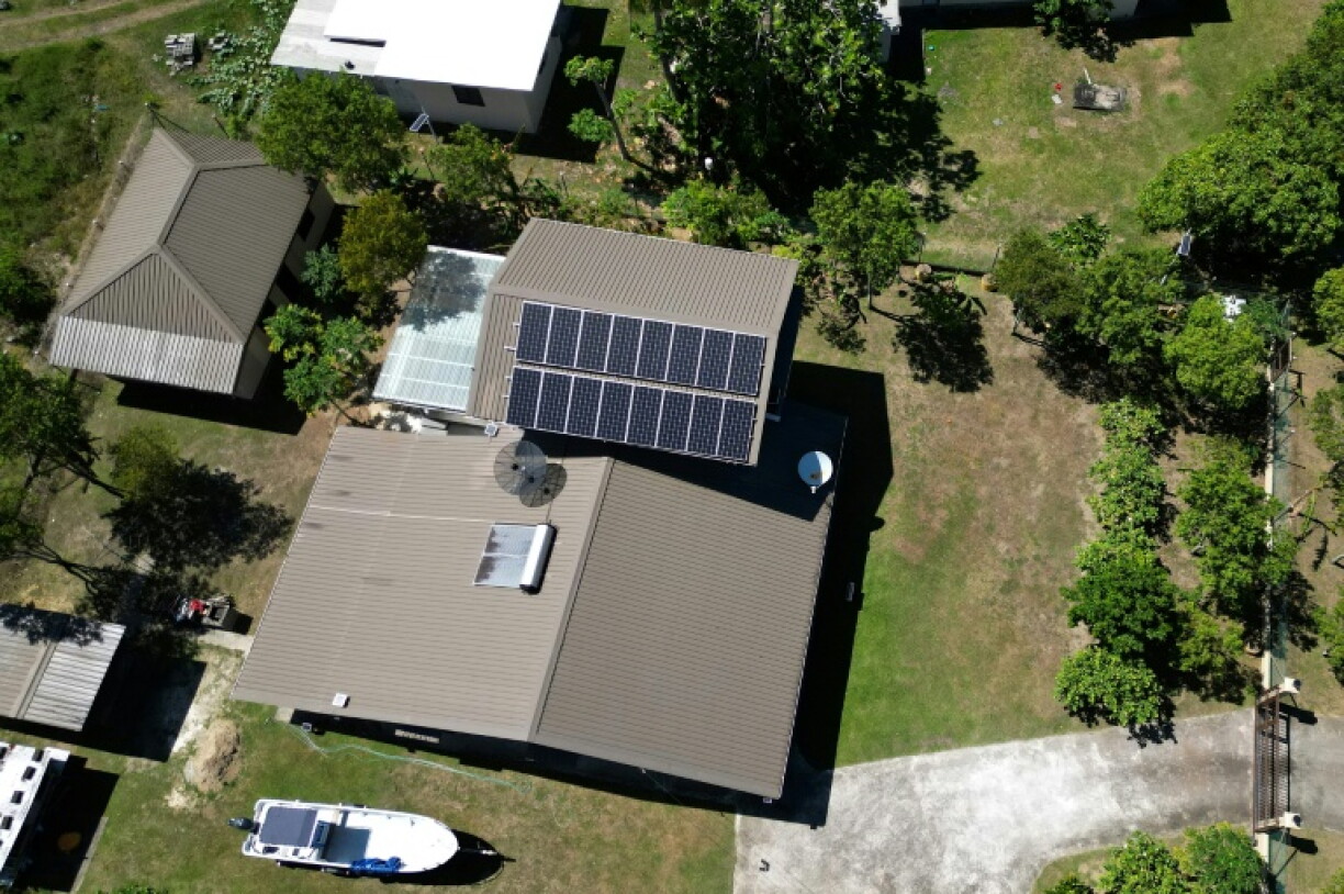This photo taken on October 9, 2026 shows an aerial view of a house fitted with solar panels in Rukurukulevu village on the coast of Fiji's Nadroga-Navosa province. As fuel prices rise, some in the village are turning to solar to move away from dependence on the national grid.