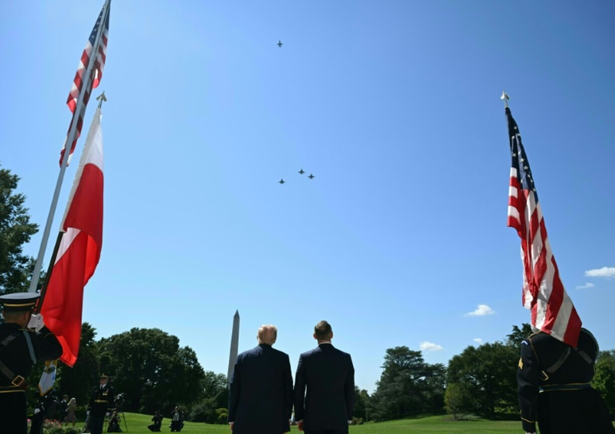 US President Donald Trump and Polish President Karol Nawrocki (R) watch a flyover of military aircraft from the South Portico of the White House