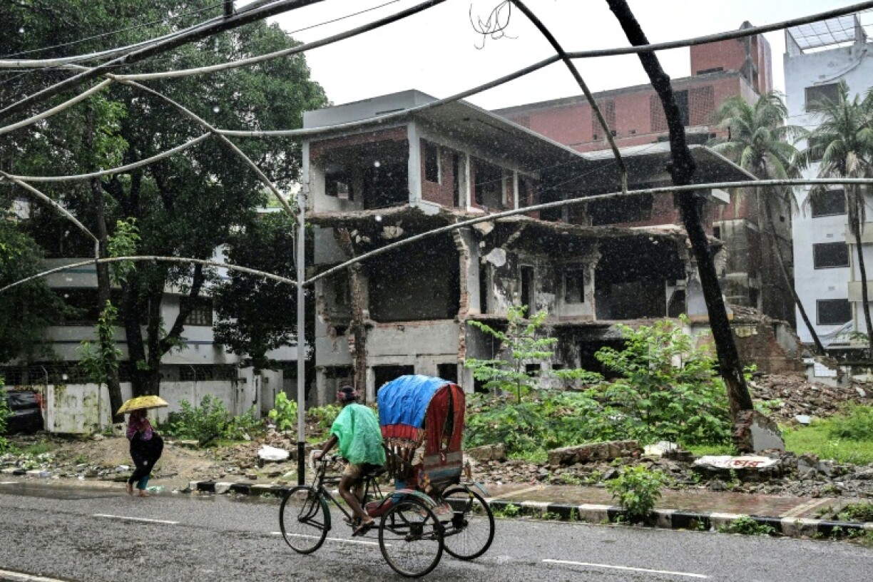 Protesters have used digger excavators to smash down the home of the late Sheikh Mujibur Rahman -- which Hasina had turned into a museum to her father