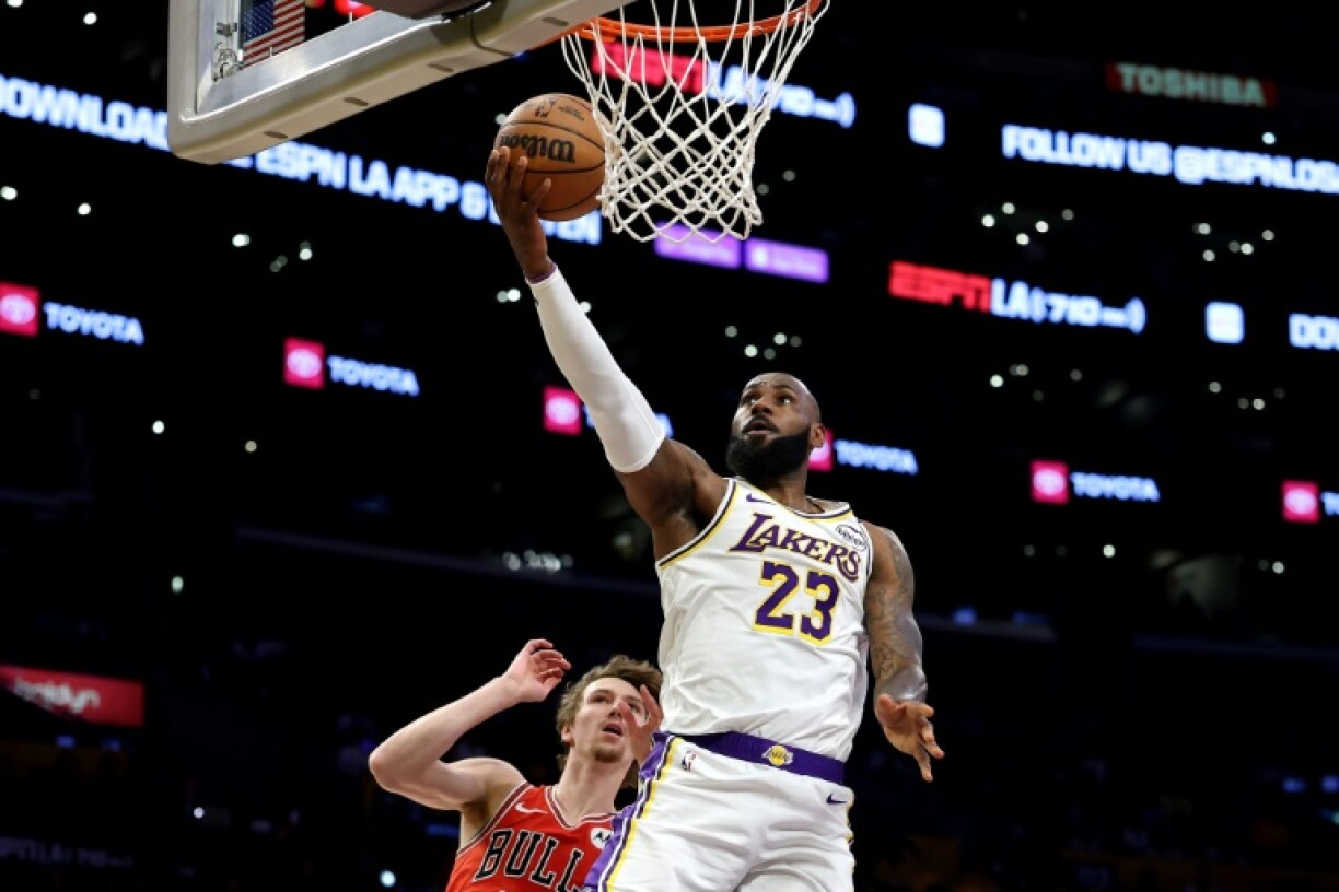 LeBron James of the Los Angeles Lakers drives to the basket against Chicago Bulls rookie Matas Buzelis