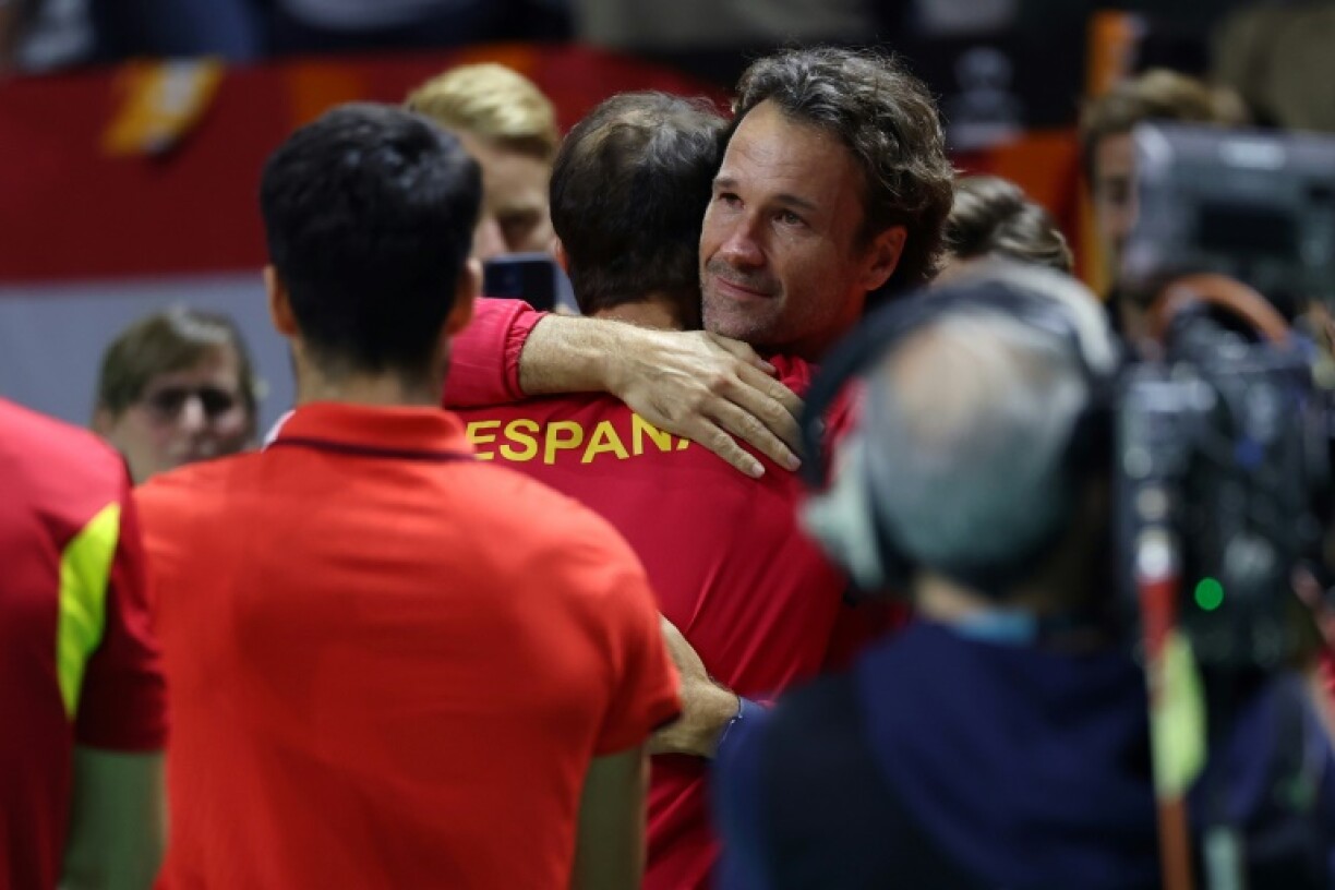 Carlos Moya hugs Rafael Nadal after his final match of a glittering career