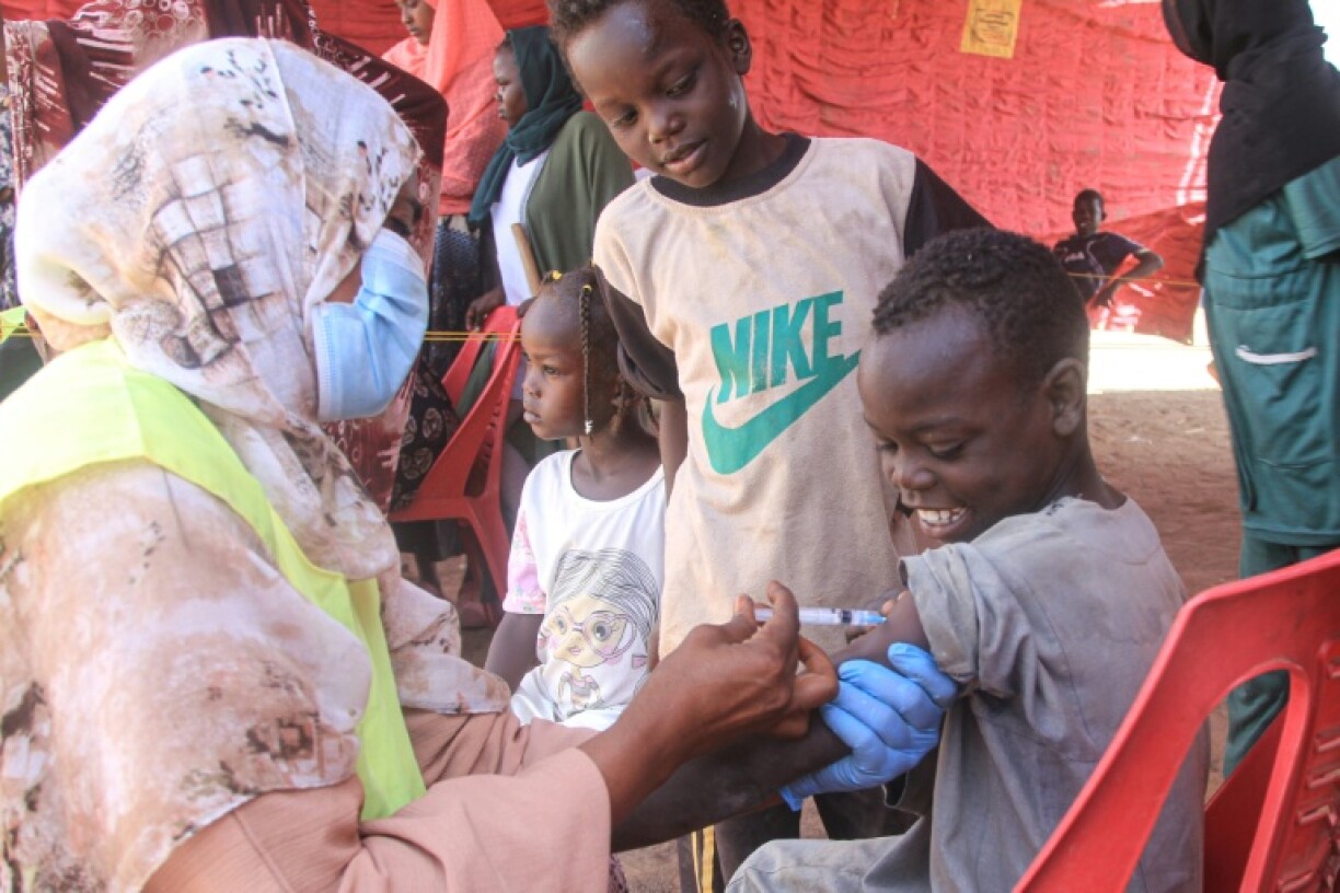 A child is vaccinated against diphtheria at the Al-Dabbah camp for displaced people in Sudan