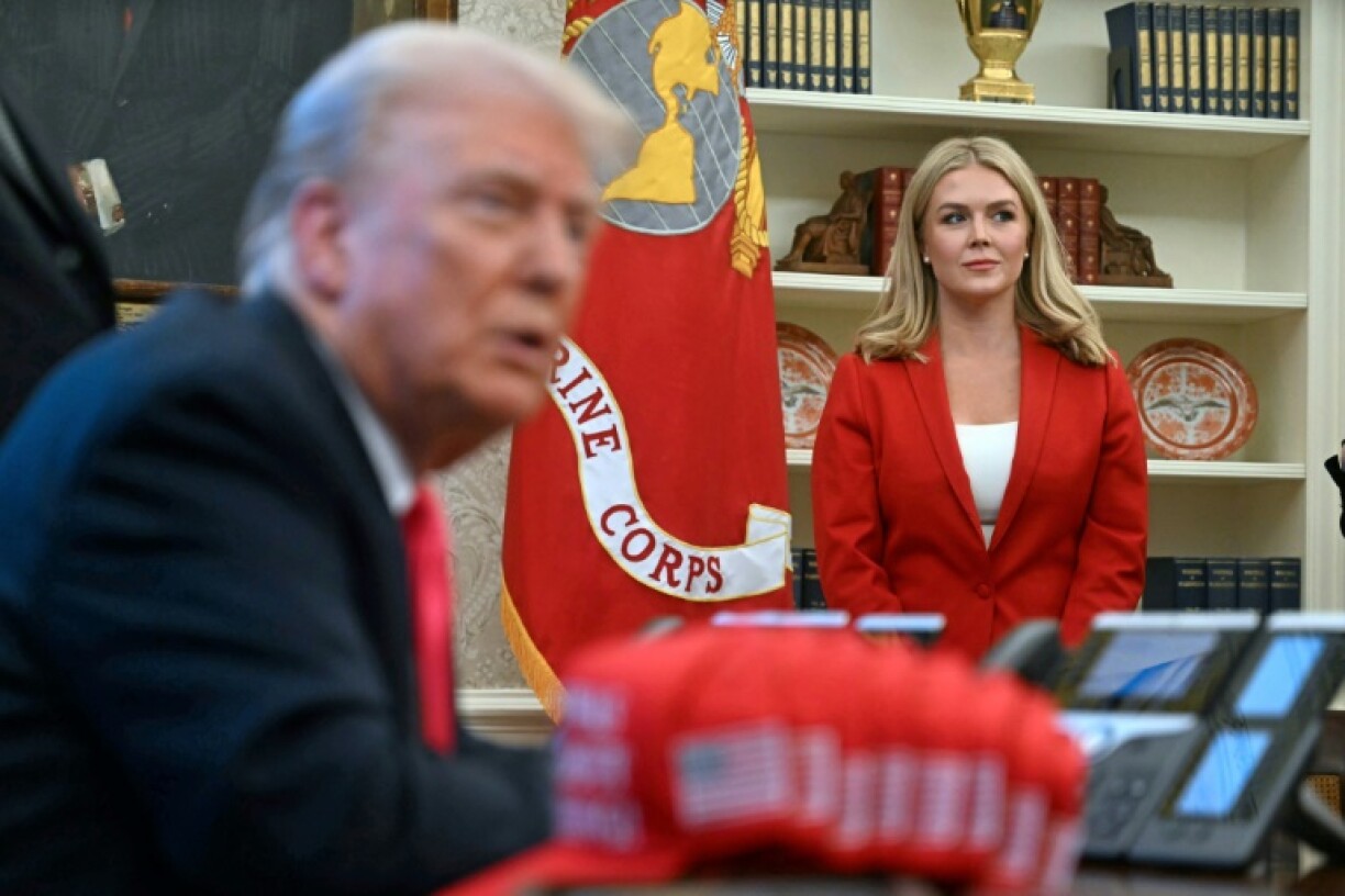 White House Press Secretary Karoline Leavitt looks on as US President Donald Trump speaks to the press at the Oval Office on February 25, 2025