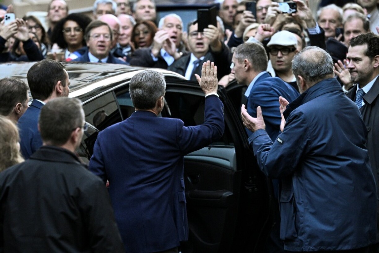 Sarkozy waved to supporters as he left his home