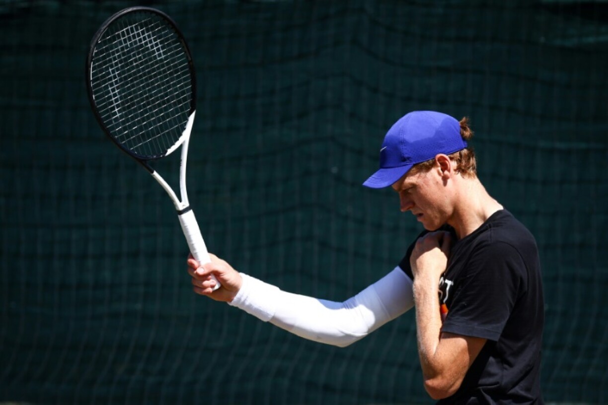 Italy's Jannik Sinner touches his shoulder during a training session at Wimbledon