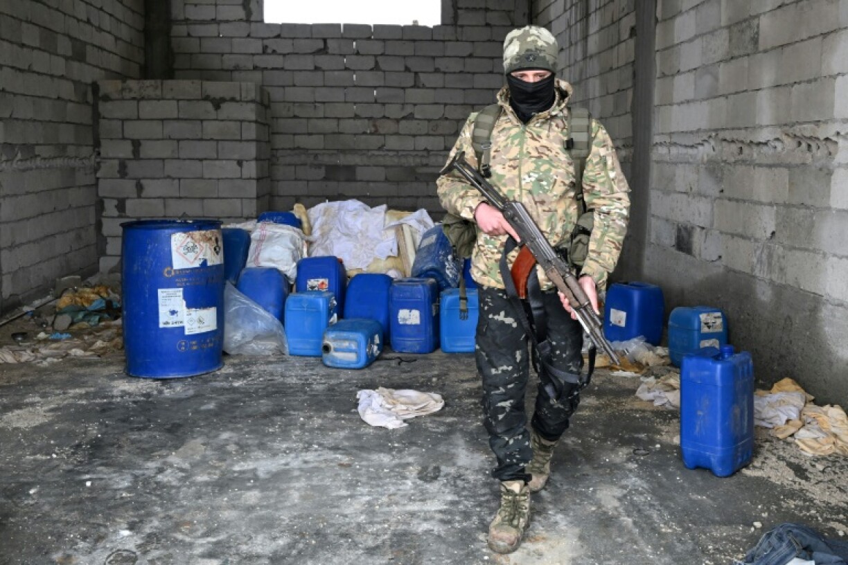 A member of the Syrian security forces searches a defunct drug factory inside an abandoned building in the countryside of Qusayr, at the porous Lebanese border