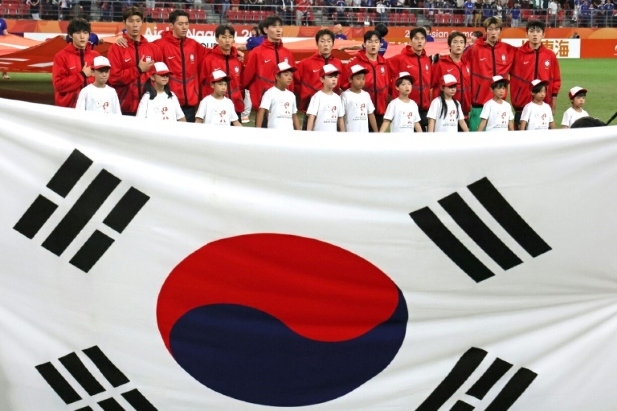 This picture taken on October 3, 2026 shows South Korea's players singing the national anthem at the Asian Games