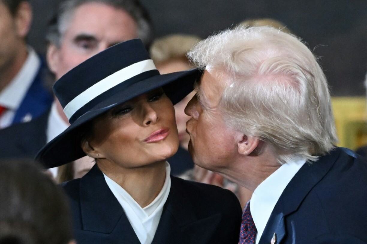 US President-elect Donald Trump kisses Melania Trump prior to his swearing-in