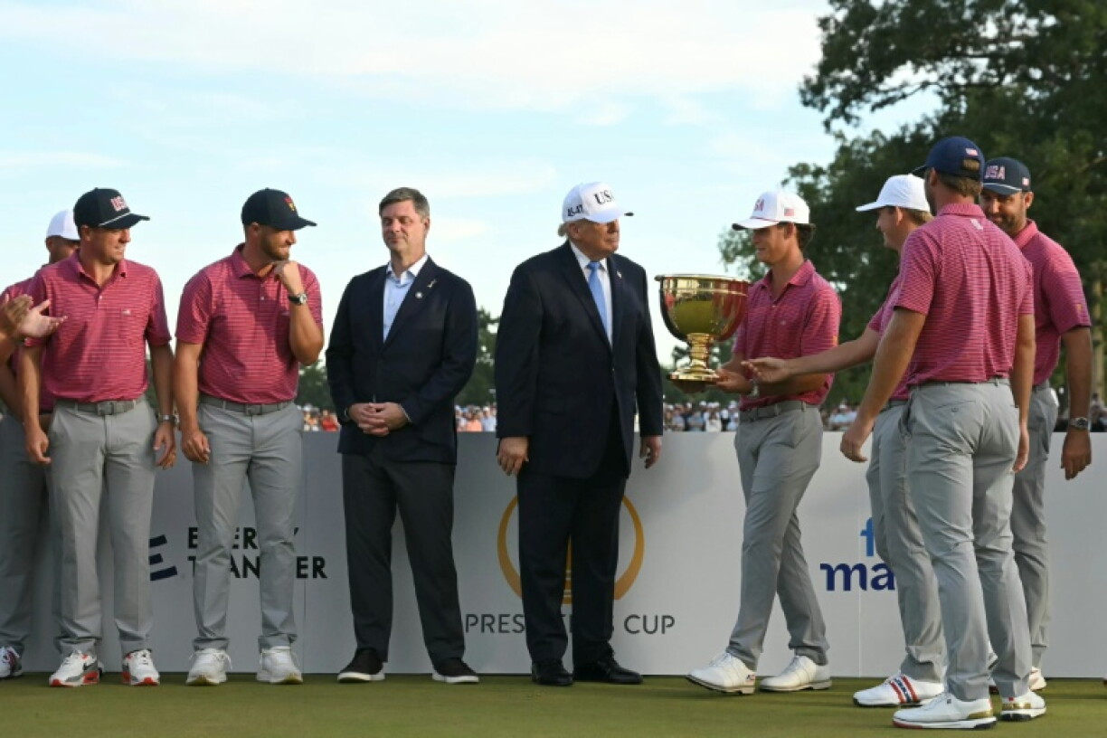 US President Donald Trump greets American golfers at the trophy ceremony of the 16th Presidents Cup at Medinah