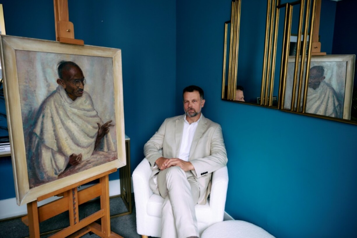 Caspar Leighton with a portrait by his great-aunt of Indian independence leader Mahatma Gandhi