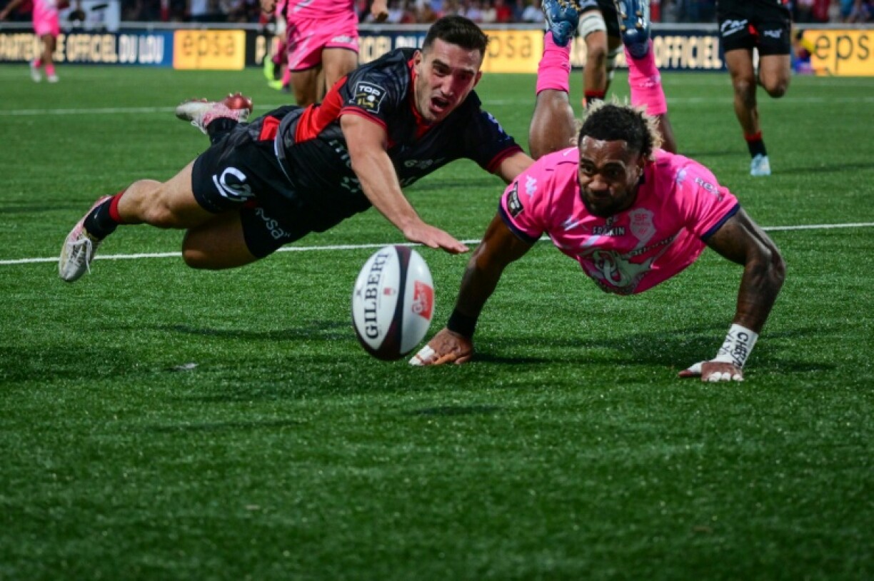 Tries from Monty Ioane, Iosefo Masi and scrum-half Baptiste Couillaud (L) inside the first 10 minutes after the restart took the game away from the Parisian visitors