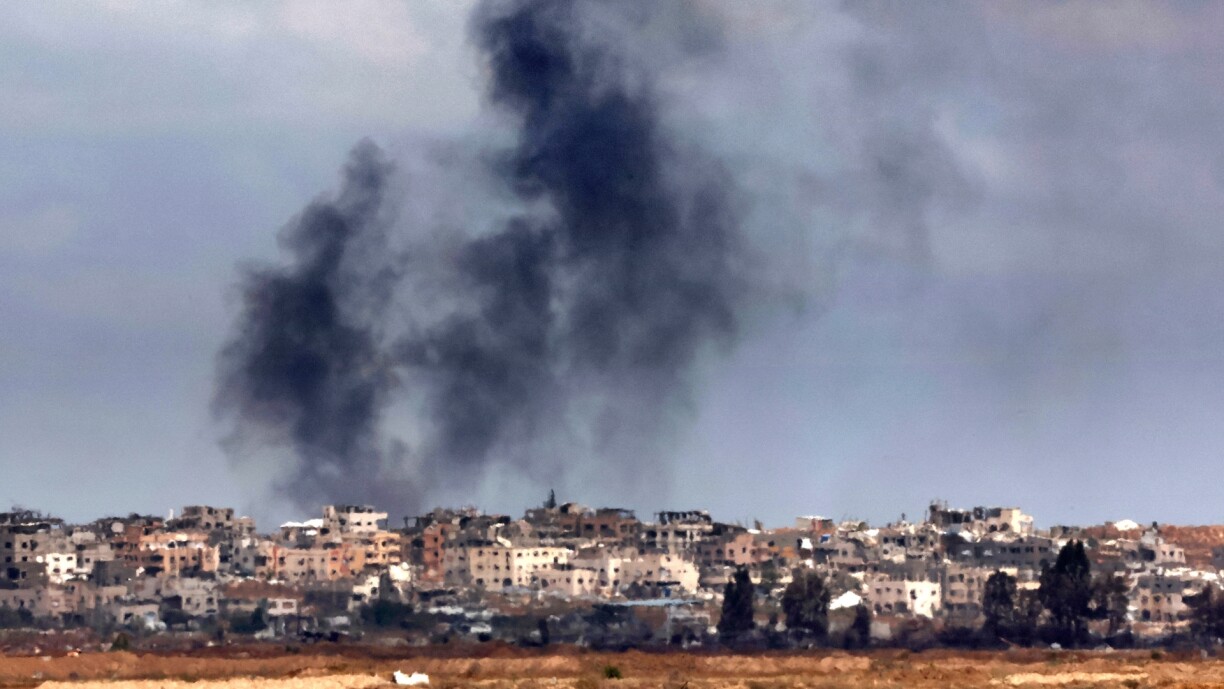 A picture taken from the Israeli side of the border with the Gaza Strip, shows smoke billowing above destroyed buildings during Israeli bombardment in the besieged Palestinian territory on 22 May 2025.