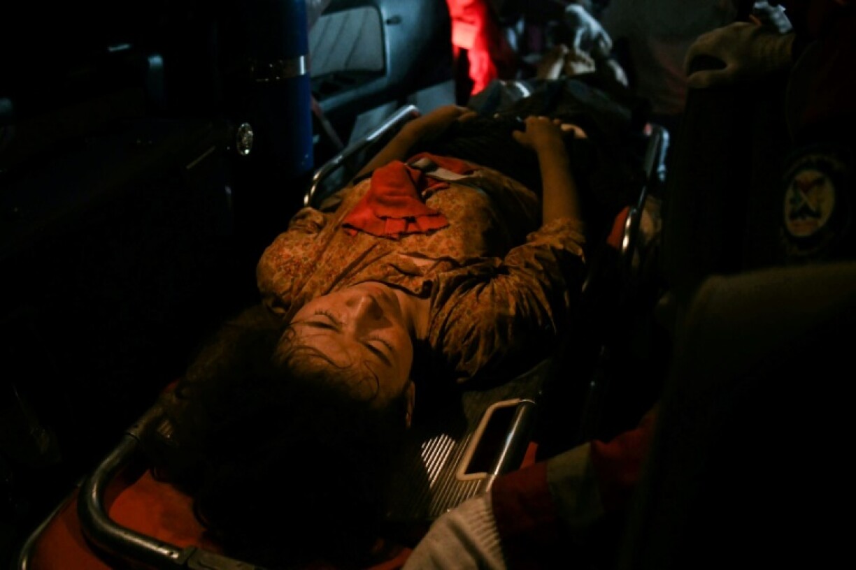 Rescuers pulled a woman out of the remains of the Sky Villa Condominium in Mandalay