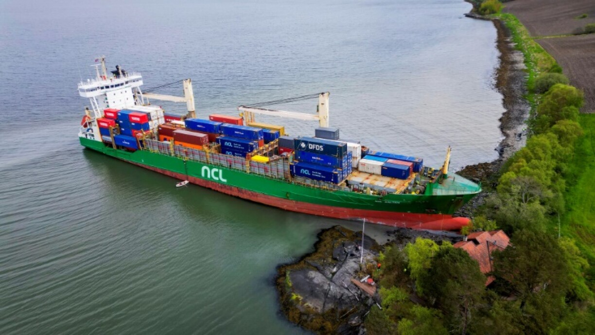 A cargo ship has been freed after running aground near a house in Norway