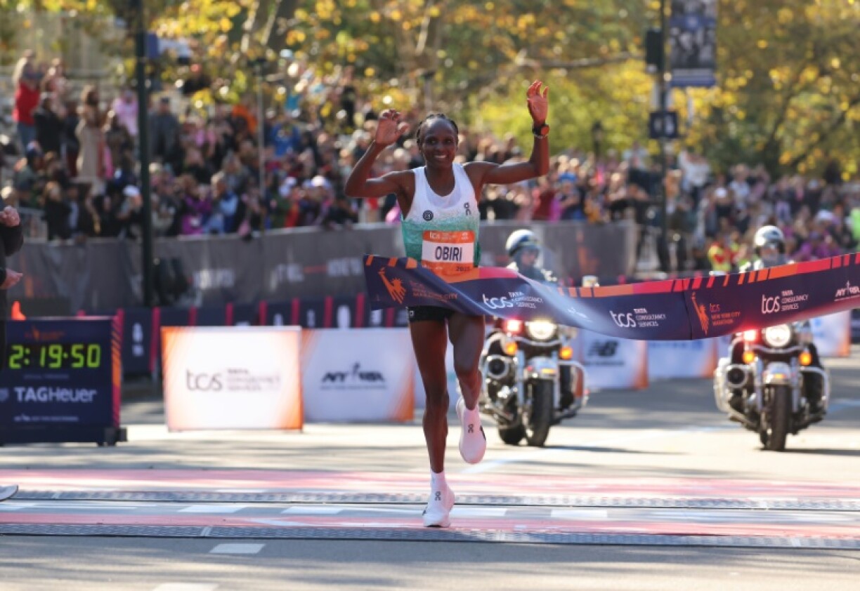 Hellen Obiri of Kenya crosses the finish line to win the New York Marathon in New York in record time.