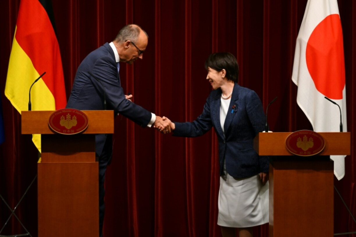 German Chancellor Friedrich Merz (L) and Japan's Prime Minister Sanae Takaichi shake hands during a joint press announcement at the Prime Minister's Office in Tokyo on October 28, 2026.
