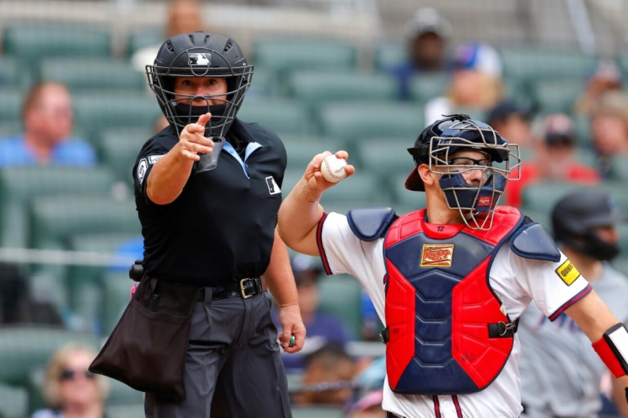 Jen Pawol, the first woman umpire in Major League Baseball, calls a strike during her first assignment behind the plate when Miami faces Atlanta