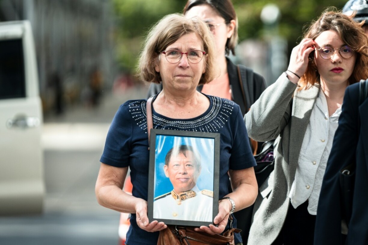 The trial of the alleged killer of a Cambodian opposition politician began in Bangkok, with his widow, Anne-Marie Lim (C), calling for the motive and mastermind behind the murder to be revealed
