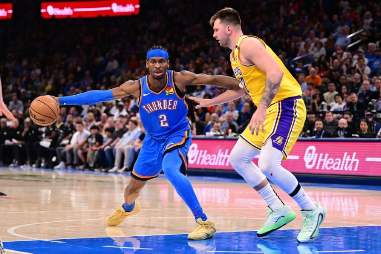 Shai Gilgeous-Alexander fends off Luka Doncic in Oklahoma City's 136-120 win over the Los Angeles Lakers