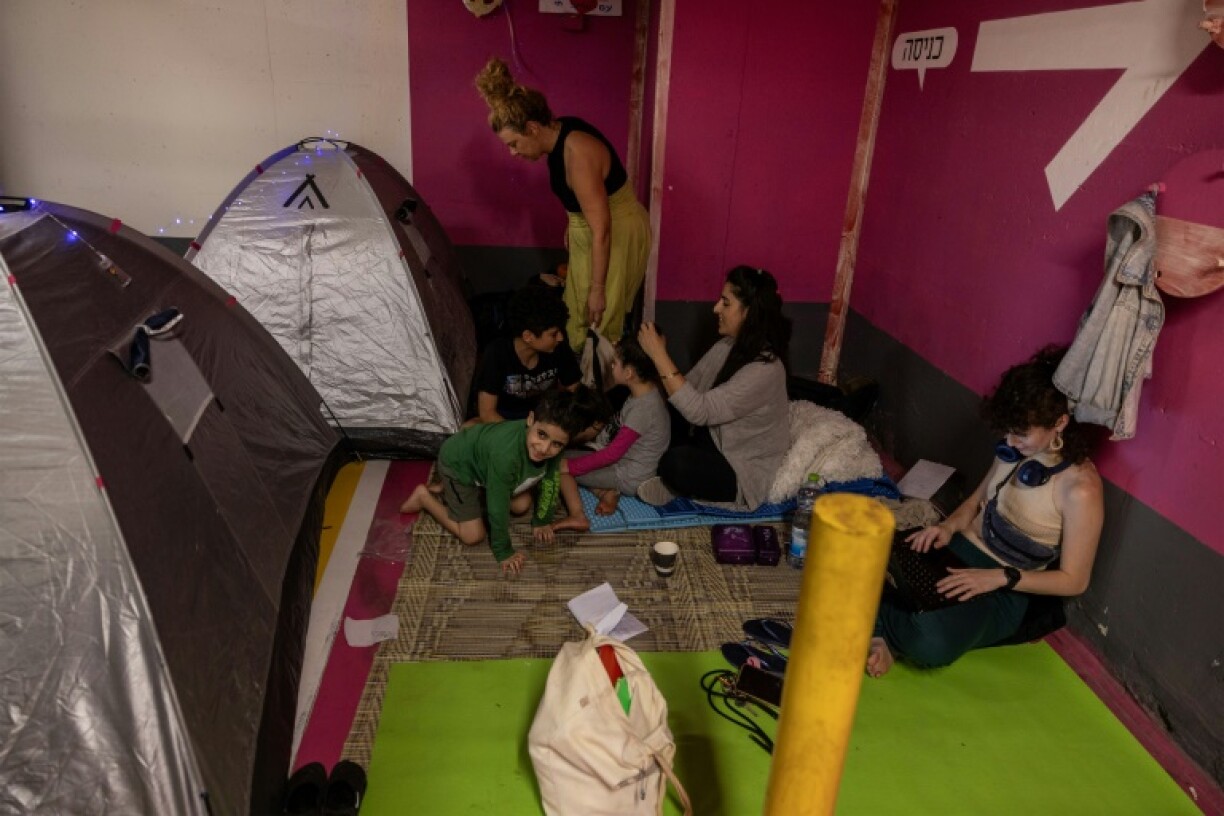 With air raid sirens regularly screaming over Tel Aviv, some relocated to an underground parking lot below a shopping mall