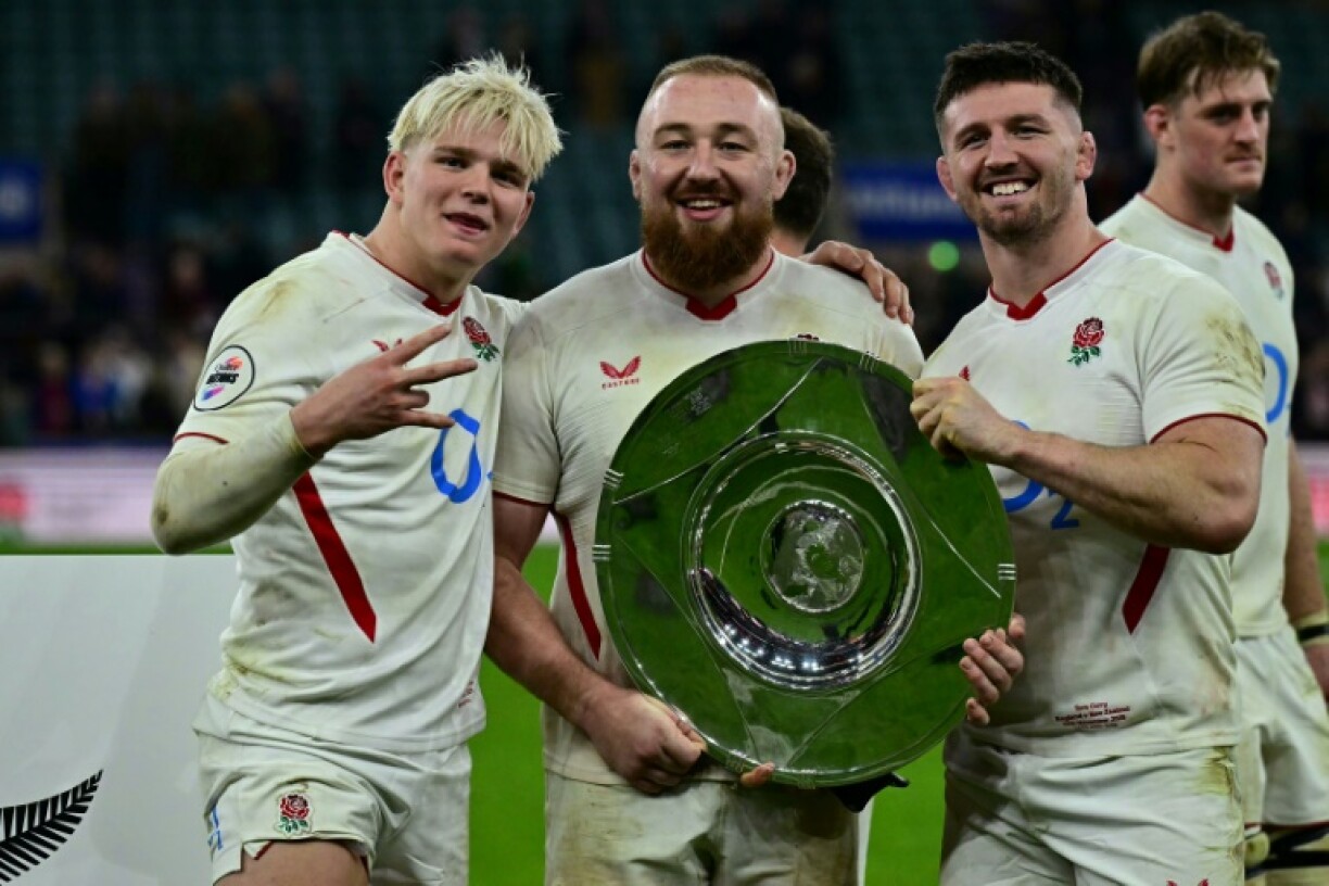 England's Henry Pollock, prop Joe Heyes and Tom Curry pose with the trophy after the impressive win against the All Blacks