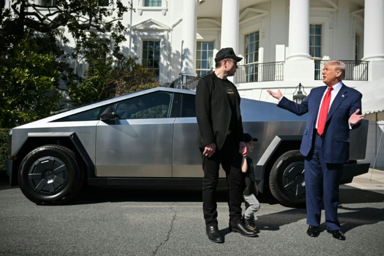 US President Donald Trump and Tesla CEO Elon Musk stand next to a Tesla Cybertruck at the South Portico of the White House